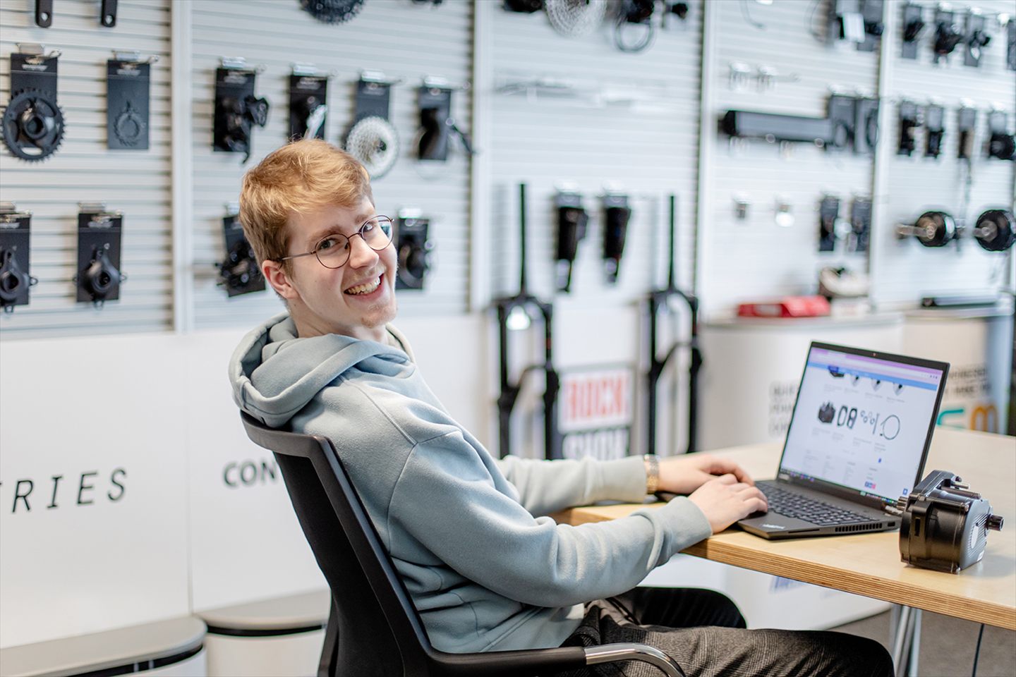 An employee working on a laptop in the showroom